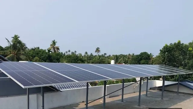 A large rooftop solar array on a raised mounting structure over a concrete terrace, with the roof underneath still usable.