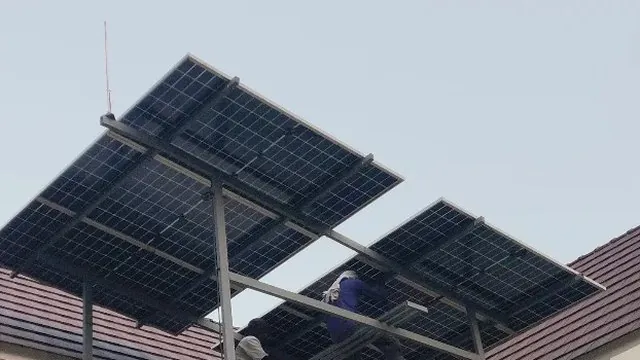 Solar panels on a tiled roof in Azhikode, Thrissur, set at pitch on tilted frames instead of following the line of the tiles.